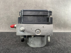 Bosch ABS brake pump module with metal control plate and black reservoir on top, shown from the front.