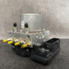 NIS-ACTR-5SK0A _2 Subaru Impreza Genuine ABS Actuator Pump 27536FL140 » NZ9.95 » JDM-PARTS NZ » JDM-PARTS NZ Automotive ABS brake module with a metal valve block, yellow-tipped fittings, and a black plastic connector housing. Subaru Impreza Genuine ABS Actuator Pump 27536FL140 » JDM-PARTS NZ