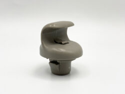 Gray plastic automotive interior knob/handle with a curved saddle-like top, mounted on a small base against a white background.”,
