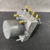 SUB-ACTR-27536SC050_2 Toyota Chaser Altezza Genuine ABS Actuator Pump 44510-24060 / 133000-5050 » NZ9.95 » JDM-PARTS NZ » JDM-PARTS NZ Close-up of a hydraulic control valve block with yellow-tipped actuators and a mounting motor on the side, on a dark surface. Toyota Chaser Altezza Genuine ABS Actuator Pump 44510-24060 / 133000-5050 » JDM-PARTS NZ
