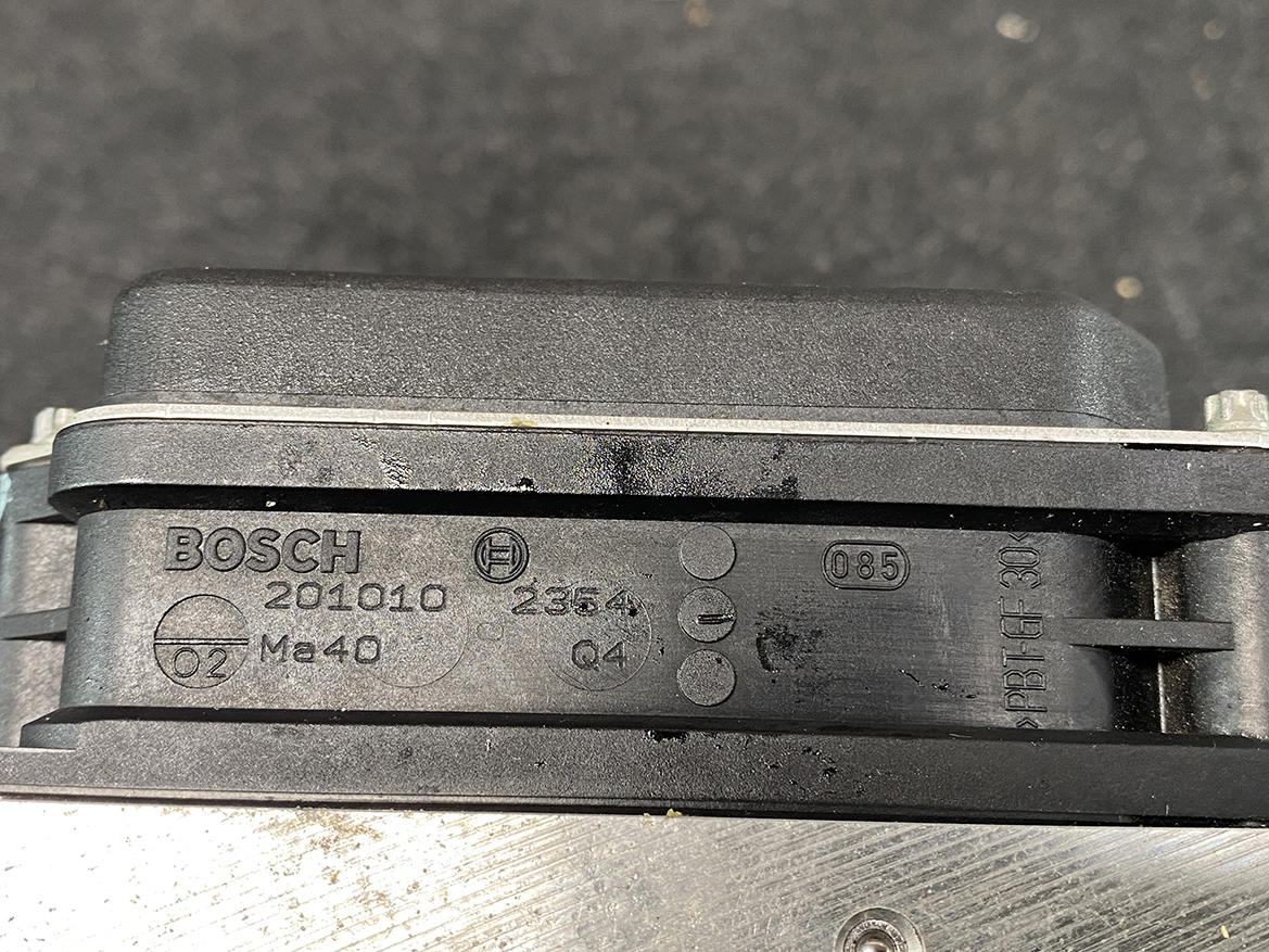 SUB-ACTR-27536SC050_6 Subaru Forester Genuine ABS Pump Module Actuator 27536SC050 » NZ9.95 » JDM-PARTS NZ » JDM-PARTS NZ Close-up of a Bosch automotive component with part numbers 201010 and Ma40 embossed on black plastic. Subaru Forester Genuine ABS Pump Module Actuator 27536SC050 » JDM-PARTS NZ