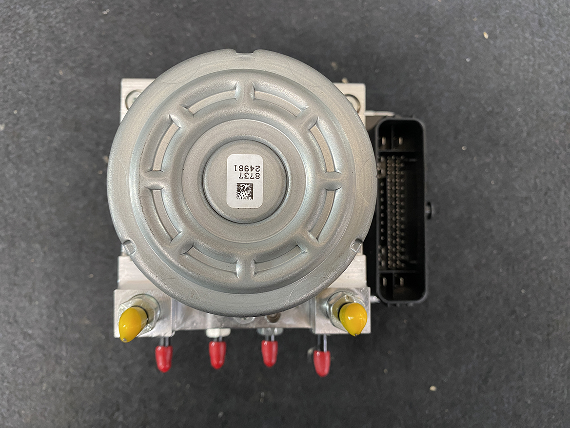 SUB-ACTR-FL140 _11 Subaru Impreza Genuine ABS Actuator Pump 27536FL140 » NZ9.95 » JDM-PARTS NZ » JDM-PARTS NZ Electrical control module with a round gray top, metal body, and a black multi-pin connector on the right; yellow and red terminal posts at the bottom. Subaru Impreza Genuine ABS Actuator Pump 27536FL140 » JDM-PARTS NZ