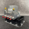 SUB-ACTR-FL140 _2 Suzuki Alto Genuine ABS Actuator Pump / 56110-74PR / 116040-40581 » NZ9.95 » JDM-PARTS NZ » JDM-PARTS NZ Automotive ABS pump module with a metal hydraulic block, four red port fittings, and yellow cap tops on a black base baseplate. Suzuki Alto Genuine ABS Actuator Pump / 56110-74PR / 116040-40581 » JDM-PARTS NZ
