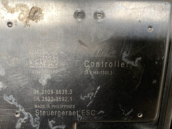 Close-up of a metal controller plate with etched text: 'Controller', part numbers, and 'Made in Philippines' (Steuergerät ESC).