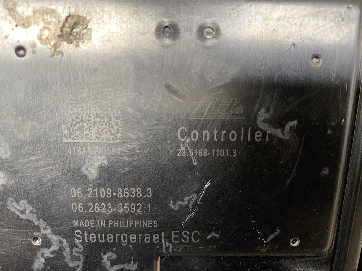 SUB-ACTR-FL140 _6 Subaru Impreza Genuine ABS Actuator Pump 27536FL140 » NZ9.95 » JDM-PARTS NZ » JDM-PARTS NZ Close-up of a metal controller plate with etched text: 'Controller', part numbers, and 'Made in Philippines' (Steuergerät ESC). Subaru Impreza Genuine ABS Actuator Pump 27536FL140 » JDM-PARTS NZ