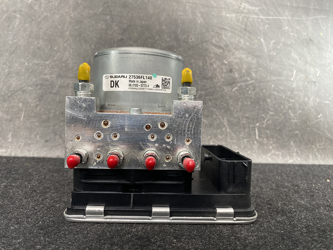 SUB-ACTR-FL140 _7 Subaru Impreza Genuine ABS Actuator Pump 27536FL140 » NZ9.95 » JDM-PARTS NZ » JDM-PARTS NZ ABS hydraulic control unit from a Subaru, metal valve block with red port caps mounted on a black base. Subaru Impreza Genuine ABS Actuator Pump 27536FL140 » JDM-PARTS NZ