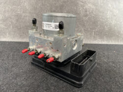 Automotive ABS hydraulic modulator with four red-tipped connectors mounted on a black base Subaru Levorg Genuine ABS Actuator Pump 27536VA010 » JDM-PARTS NZ