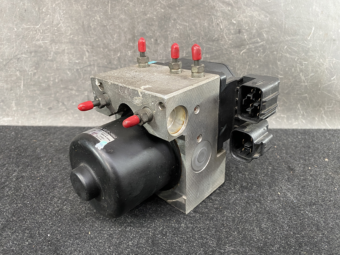 TOY-ACTR-24060_2 Toyota Chaser Altezza Genuine ABS Actuator Pump 44510-24060 / 133000-5050 » NZ9.95 » JDM-PARTS NZ » JDM-PARTS NZ Automotive ABS pump and valve block with electrical connectors and red-tipped ports. Toyota Chaser Altezza Genuine ABS Actuator Pump 44510-24060 / 133000-5050 » JDM-PARTS NZ