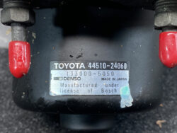 Close-up of a car part label: TOYOTA 44510-24060 with Denso, Made in Japan, showing licensing under Bosch.