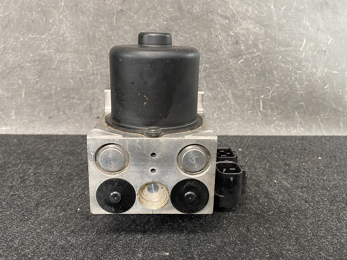 TOY-ACTR-24060_7 Toyota Chaser Altezza Genuine ABS Actuator Pump 44510-24060 / 133000-5050 » NZ9.95 » JDM-PARTS NZ » JDM-PARTS NZ Automotive ABS brake pump module with metal block, black top, and electrical connector on the side. Toyota Chaser Altezza Genuine ABS Actuator Pump 44510-24060 / 133000-5050 » JDM-PARTS NZ