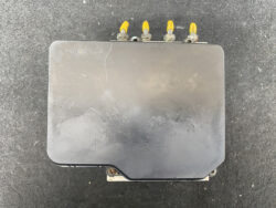 Black rectangular automotive electronic module with four yellow-tipped connectors on top, mounted to a metal bracket at bottom edge.