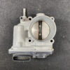 TOY-TB-37050_2 Nissan SERENA SUZUKI LANDY C26 Genuine Throttle Body 526-01 » NZ9.95 » JDM-PARTS NZ » JDM-PARTS NZ Close-up of a car throttle body with two butterfly valves visible inside and an electrical connector at the bottom. Nissan SERENA SUZUKI LANDY C26 Genuine Throttle Body 526-01 » JDM-PARTS NZ