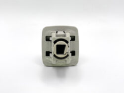Rear view of a gray 12V car power outlet module with circular socket opening and mounting frame