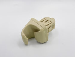 Beige plastic electrical connector housing with a latch, wiring harness end piece