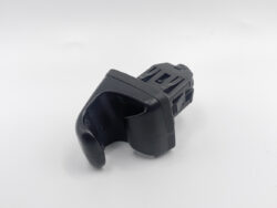 Black plastic automotive component with a curved hook-like front and vented rear section, likely a mount or switch housing used inside a vehicle