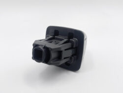 Black automotive switch module with a square socket receptacle mounted on a curved base.