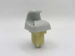 Close-up of a gray plastic lever-like cover mounted on a yellow electrical connector housing.