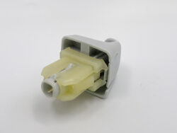 Close-up of a gray plastic connector housing with a yellow insert and a cylindrical end, likely a medical or laboratory quick-connect component.
