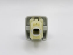 Close-up of a beige electrical connector inside a gray mounting frame