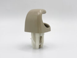Beige curved plastic helmet accessory mounted on a white clip-on base, photographed against a plain background.