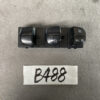 Black automotive power window switch panel with four rocker switches, including window lock icons, placed above a white card labeled B488. NISSAN ELGRAND E52 Genuine Master Power Window & Mirror Switch 25401 1JB5C » JDM-PARTS NZ