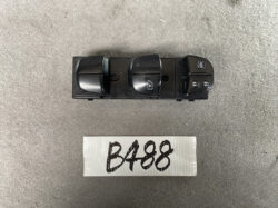 Black automotive power window switch panel with four rocker switches, including window lock icons, placed above a white card labeled B488.