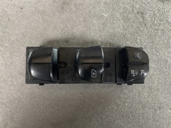 Car power window switch panel with four window controls and lock buttons on a black plastic base