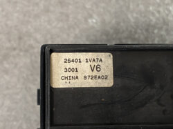 Close-up of a beige label on a black plastic device, showing model and batch numbers: 25401 1VA7A, 3001 V6, CHINA 972EA02.