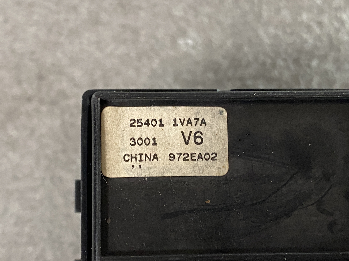 B488_4 NISSAN SERENA SUZUKI LANDY C26 Genuine Master Power Window Switch 25401 1VA7A » NZ.95 » JDM-PARTS NZ » JDM-PARTS NZ Close-up of a beige label on a black plastic device, showing model and batch numbers: 25401 1VA7A, 3001 V6, CHINA 972EA02. NISSAN SERENA SUZUKI LANDY C26 Genuine Master Power Window Switch 25401 1VA7A » JDM-PARTS NZ