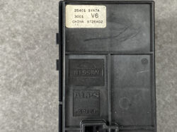 Nissan automotive control module by ALPS with a beige sticker and part numbers on top surface with a black plastic housing.