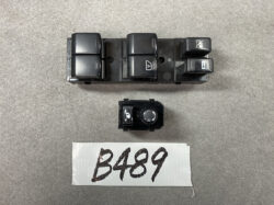 Automotive power window and mirror control switch module with four window buttons and a rotary mirror-adjustment knob, shown with a B489 label beneath.