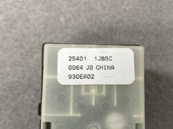 Close-up of a gray electronic module with a white label showing batches/serial numbers (e.g., 25401 1JB5C, 0064 JO CHINA, 930EA02).