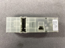 Nissan automotive electronic control module (ECU) in a translucent plastic case with two large multi-pin connectors visible.