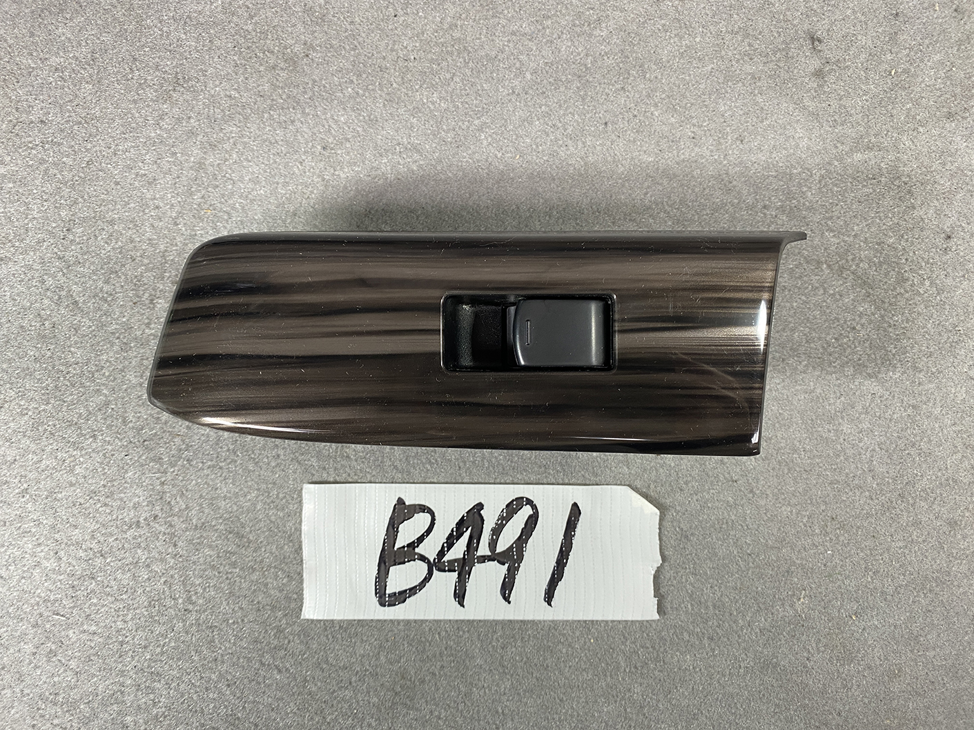 B491_2 NISSAN ELGRAND E52 Genuine Front Left Power Window Switch 25411 JD05A » NZ.95 » JDM-PARTS NZ » JDM-PARTS NZ Woodgrain car interior panel with a single black window switch in the center. NISSAN ELGRAND E52 Genuine Front Left Power Window Switch 25411 JD05A » JDM-PARTS NZ