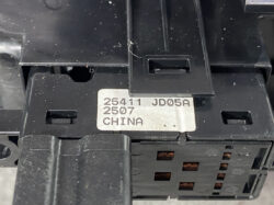 Close-up of a black electrical breaker with a metal label reading '25411 JD05A 2507 CHINA' on top edge.