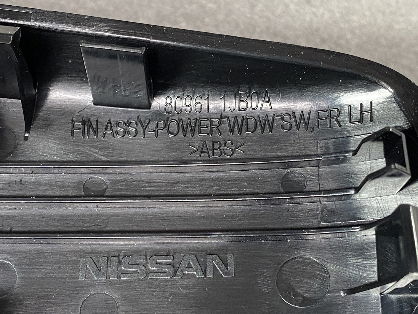 B491_5 NISSAN ELGRAND E52 Genuine Front Left Power Window Switch 25411 JD05A » NZ.95 » JDM-PARTS NZ » JDM-PARTS NZ Nissan front left power window switch assembly in black plastic with part numbers and ABS marking on it, photographed up close. NISSAN ELGRAND E52 Genuine Front Left Power Window Switch 25411 JD05A » JDM-PARTS NZ