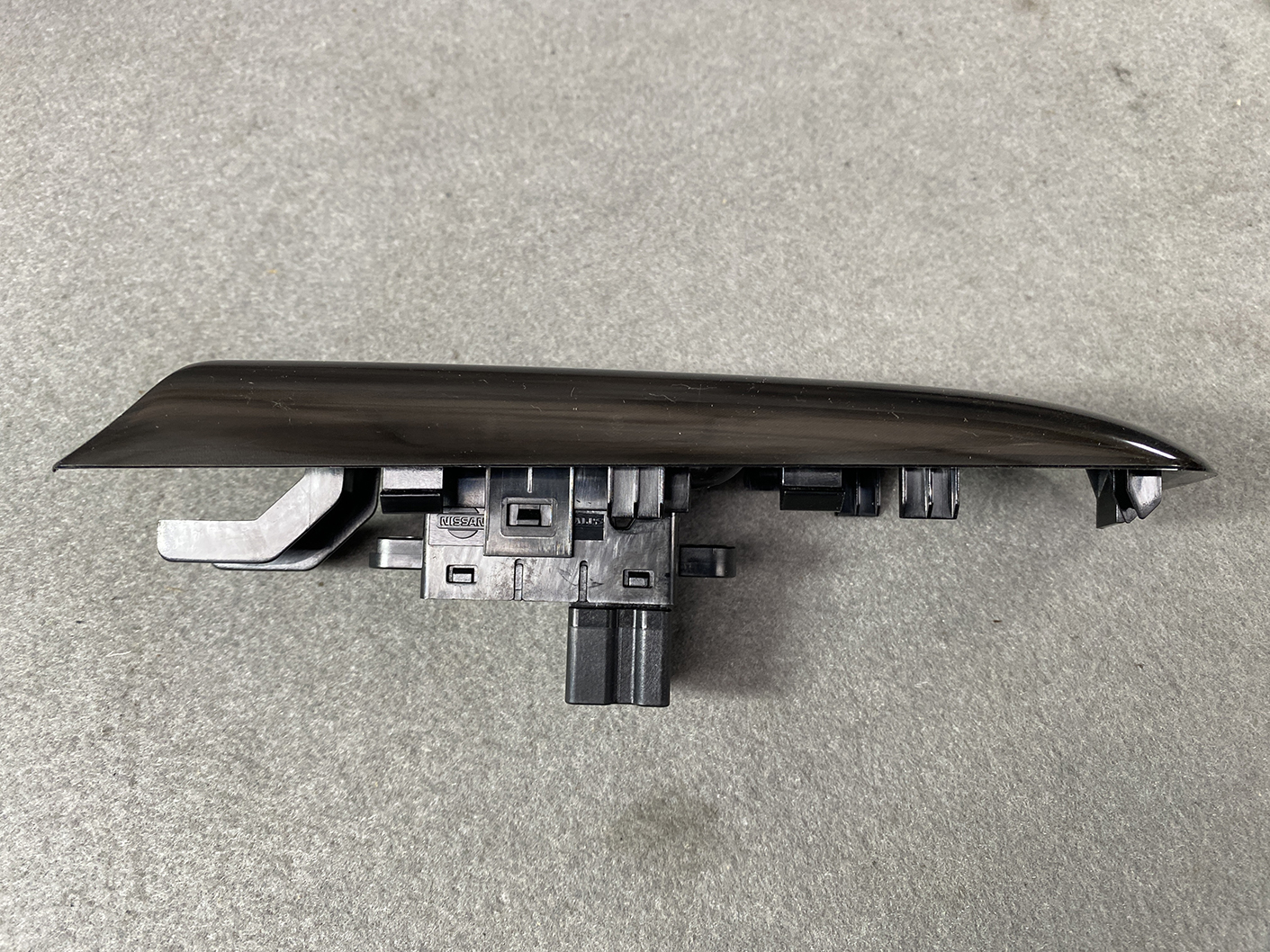 B491_7 NISSAN ELGRAND E52 Genuine Front Left Power Window Switch 25411 JD05A » NZ.95 » JDM-PARTS NZ » JDM-PARTS NZ Nissan power window switch panel with wiring connector, black and curved trim piece for a car door interior NISSAN ELGRAND E52 Genuine Front Left Power Window Switch 25411 JD05A » JDM-PARTS NZ
