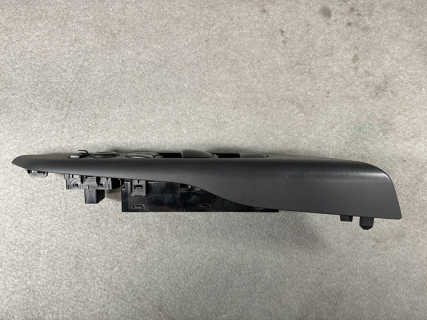 B492_9 NISSAN SERENA SUZUKI LANDY C27 Master Power Window Switch 25401 5TA0A » NZ1.95 » JDM-PARTS NZ » JDM-PARTS NZ Black plastic car door window switch panel with multiple buttons and mounting clips, viewed from the side NISSAN SERENA SUZUKI LANDY C27 Master Power Window Switch 25401 5TA0A » JDM-PARTS NZ