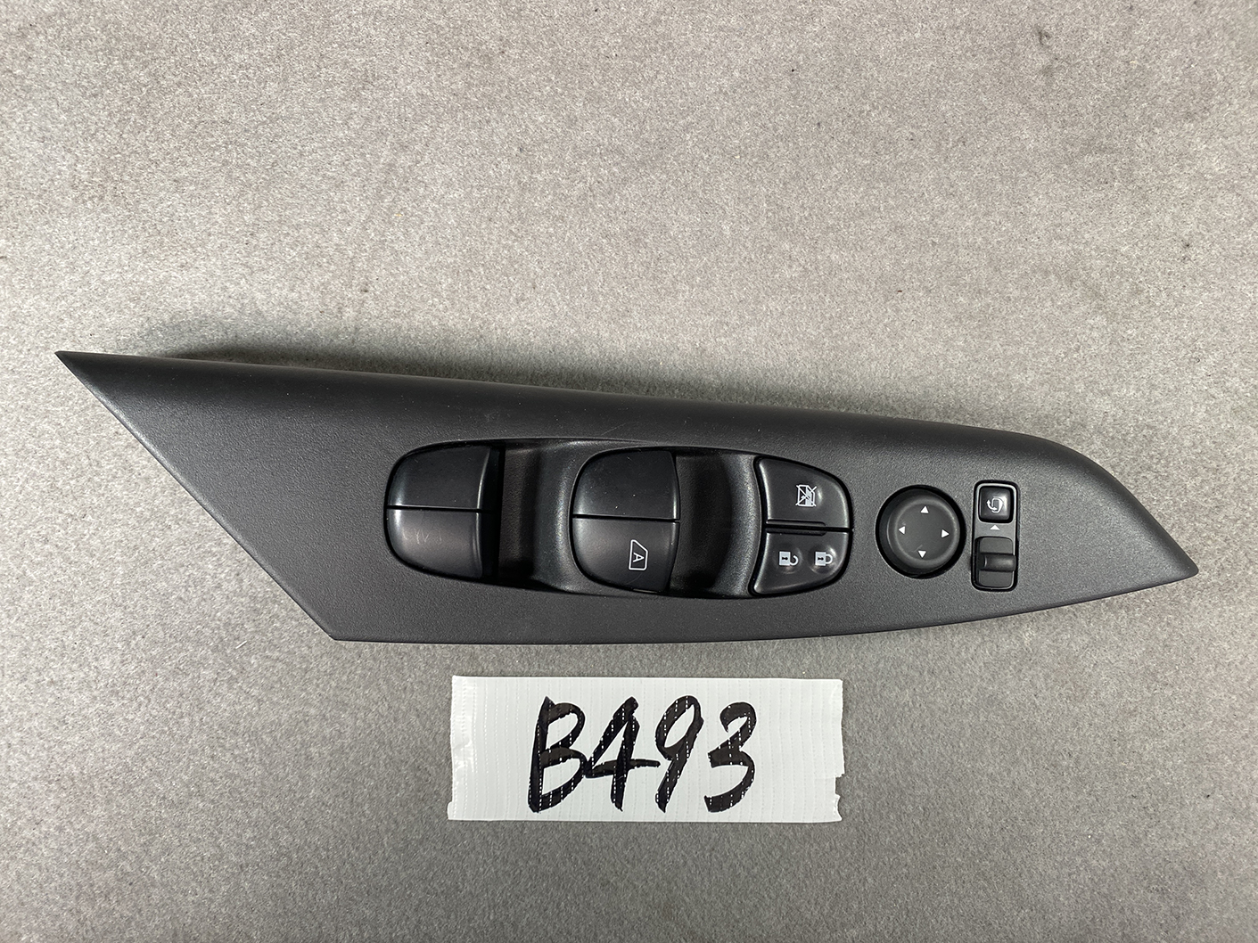 B493_2 NISSAN SERENA SUZUKI LANDY C27 Master Power Window Switch 25401 5TT0A » NZ1.95 » JDM-PARTS NZ » JDM-PARTS NZ Car door control panel: four power window switches, door lock buttons, and a circular mirror-adjustment joystick on a black curved armrest piece. NISSAN SERENA SUZUKI LANDY C27 Master Power Window Switch 25401 5TT0A » JDM-PARTS NZ