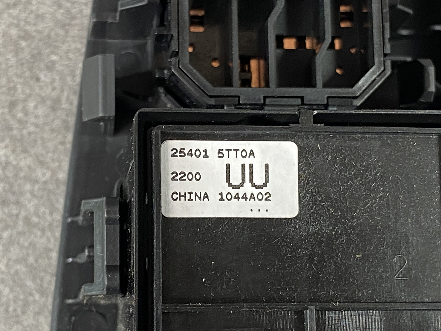 B493_4 NISSAN SERENA SUZUKI LANDY C27 Master Power Window Switch 25401 5TT0A » NZ1.95 » JDM-PARTS NZ » JDM-PARTS NZ Close-up of a black electrical module with a silver ID label reading 25401 STTOA, 2200, UU, CHINA 1044A02. NISSAN SERENA SUZUKI LANDY C27 Master Power Window Switch 25401 5TT0A » JDM-PARTS NZ
