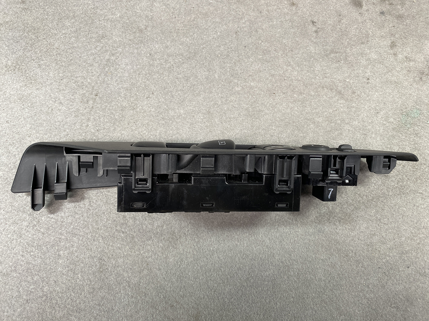 B493_9 NISSAN SERENA SUZUKI LANDY C27 Master Power Window Switch 25401 5TT0A » NZ1.95 » JDM-PARTS NZ » JDM-PARTS NZ Black plastic car window switch panel (power window control) viewed from side, showing multiple button slots and housings. NISSAN SERENA SUZUKI LANDY C27 Master Power Window Switch 25401 5TT0A » JDM-PARTS NZ