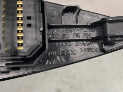 Close-up of a Nissan power connector housing with gold pins and molded part numbers (e.g., 80960 3NE0A)