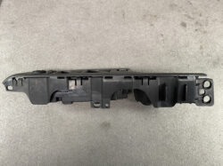 Black plastic instrument cluster housing from a car, showing mounting tabs and internal cavities for components.