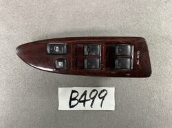Woodgrain car window control panel with six black switches and an 'ALL AUTO' label on the door trim.