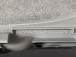 Close-up of a gray plastic component with the embossed part number 74231-52290.