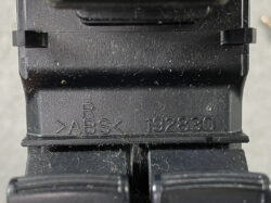Close-up of a black plastic part showing molded markings >ABS< and the code 192830 (likely a molded plastic electrical component).