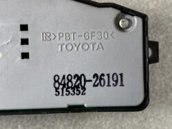 Close-up of a gray Toyota car part housing with embossed text 'PBT-GF30' and stamped part numbers 84820-26191/A57532 on the casing