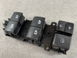 Close-up of a black car door switch panel with six power window/lock switches.