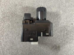 Toyota switch module with knurled rotary dial on top and white connector at bottom.