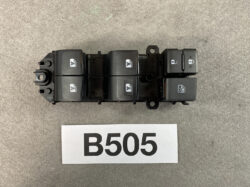 Car door master control panel with multiple window switches and lock button, used to operate a vehicle's power windows and door locks (B505 label shown).